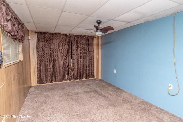 1165 5th St, Macclenny, FL 32063 - carpeted spare room with ceiling fan, wood walls, and a drop ceiling