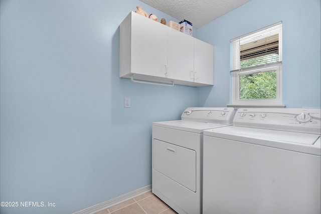 2760 Graniteridge Ct, Orange Park, FL 32065 - laundry room featuring washer and clothes dryer, cabinet space, baseboards, light tile patterned flooring, and a textured ceiling