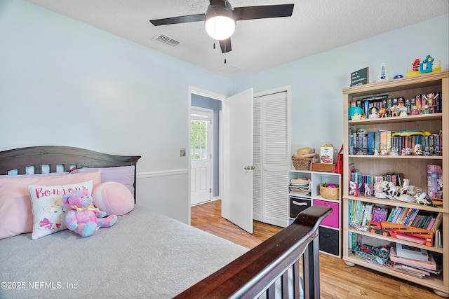 2760 Graniteridge Ct, Orange Park, FL 32065 - bedroom featuring wood finished floors, a closet, a ceiling fan, and a textured ceiling