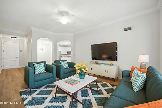 4300 S Beach Pkwy Unit 3214, Jacksonville Beach, FL 32250 - living area with ornamental molding, arched walkways, hardwood / wood-style flooring, ceiling fan, and baseboards