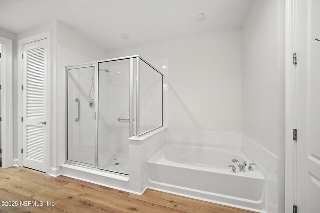 4300 S Beach Pkwy Unit 3214, Jacksonville Beach, FL 32250 - bathroom with a garden tub, a stall shower, and wood finished floors