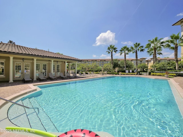 4300 S Beach Pkwy Unit 3214, Jacksonville Beach, FL 32250 - community pool with french doors and a patio