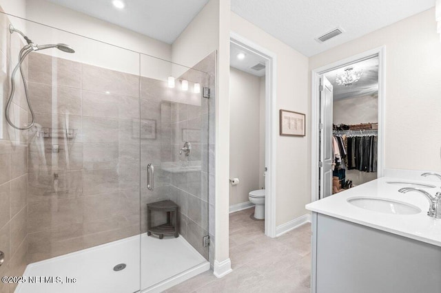 3603 Marsh Reserve Blvd, Jacksonville, FL 32224 - bathroom with a shower stall, toilet, double vanity, a spacious closet, and tile patterned floors