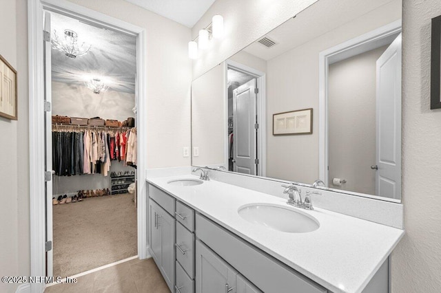 3603 Marsh Reserve Blvd, Jacksonville, FL 32224 - bathroom featuring double vanity, a spacious closet, and tile patterned floors
