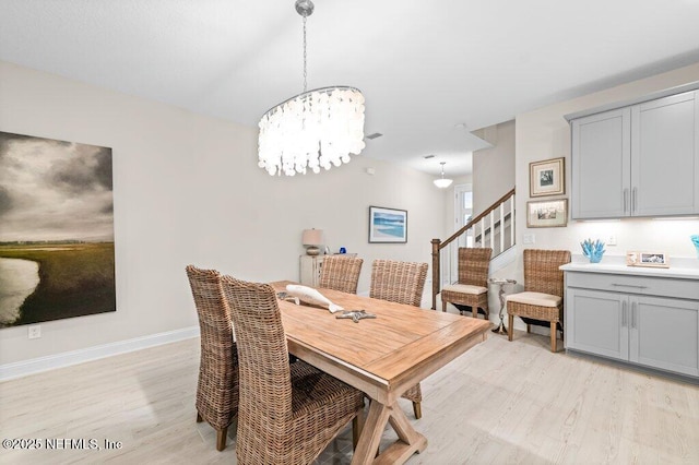 3603 Marsh Reserve Blvd, Jacksonville, FL 32224 - dining area with light wood finished floors, stairs, a chandelier, and baseboards