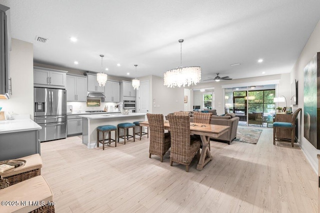 3603 Marsh Reserve Blvd, Jacksonville, FL 32224 - dining room featuring a chandelier, light wood-style flooring, a ceiling fan, and recessed lighting