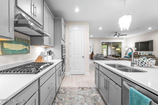 3603 Marsh Reserve Blvd, Jacksonville, FL 32224 - kitchen featuring gray cabinets, stainless steel appliances, under cabinet range hood, a sink, and light countertops