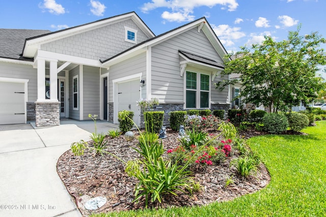 101 Bucktail Ave, Ponte Vedra, FL 32081 - craftsman house with a garage, driveway, stone siding, and a front yard