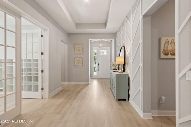 101 Bucktail Ave, Ponte Vedra, FL 32081 - entryway with light wood-style flooring, french doors, and a tray ceiling