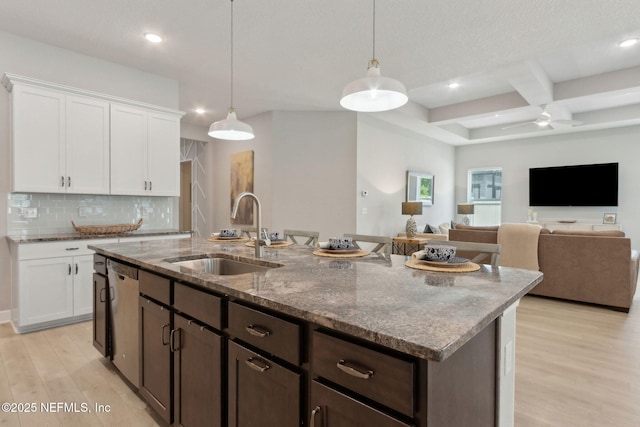 101 Bucktail Ave, Ponte Vedra, FL 32081 - kitchen featuring dishwasher, coffered ceiling, light wood-style flooring, a kitchen island with sink, and decorative backsplash