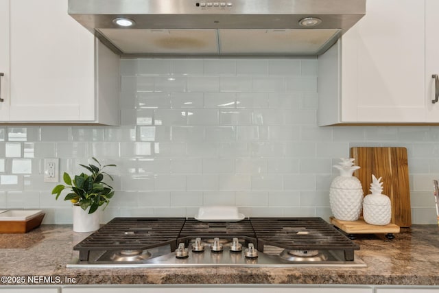 101 Bucktail Ave, Ponte Vedra, FL 32081 - kitchen view of stainless steel gas cooktop, backsplash, extractor fan, and white cabinets