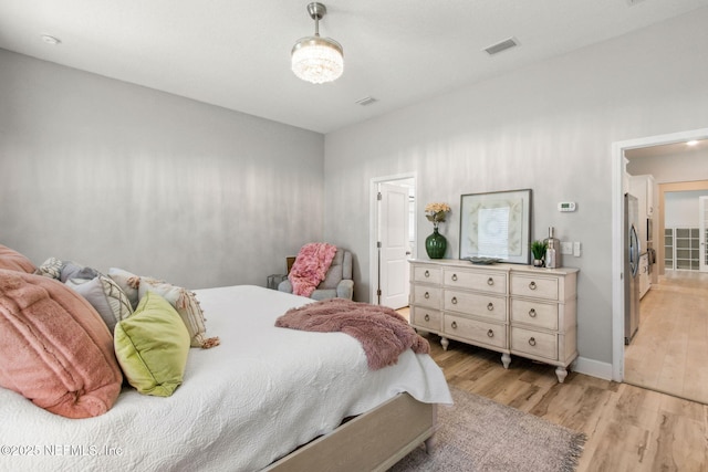101 Bucktail Ave, Ponte Vedra, FL 32081 - bedroom with light wood-style flooring and freestanding refrigerator