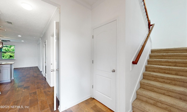 4171 Fishing Creek Ln, Middleburg, FL 32068 - stairway with ornamental molding, wood finished floors, and recessed lighting