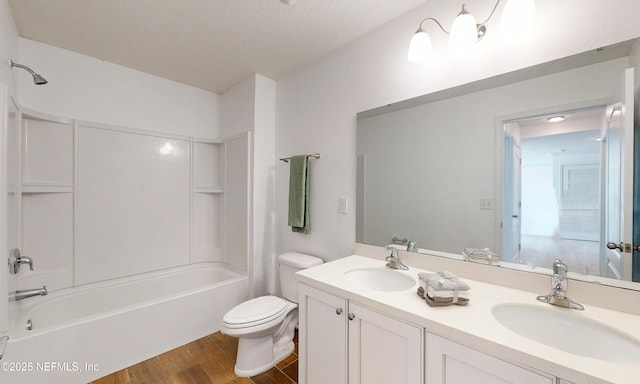 4171 Fishing Creek Ln, Middleburg, FL 32068 - full bathroom with wood finished floors, double vanity, toilet, and  shower combination