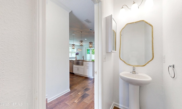 4171 Fishing Creek Ln, Middleburg, FL 32068 - bathroom with wood finished floors, a sink, and baseboards