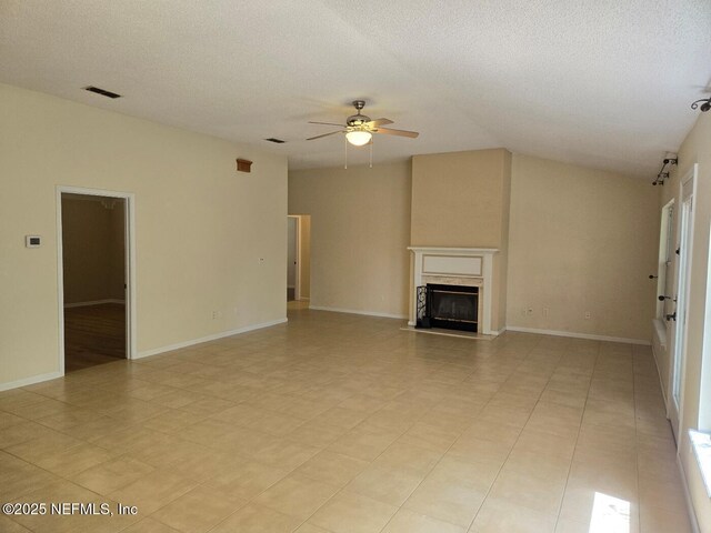 424 Bay Point Way N, Saint Johns, FL 32259 - unfurnished living room featuring ceiling fan, a glass covered fireplace, a textured ceiling, vaulted ceiling, and baseboards