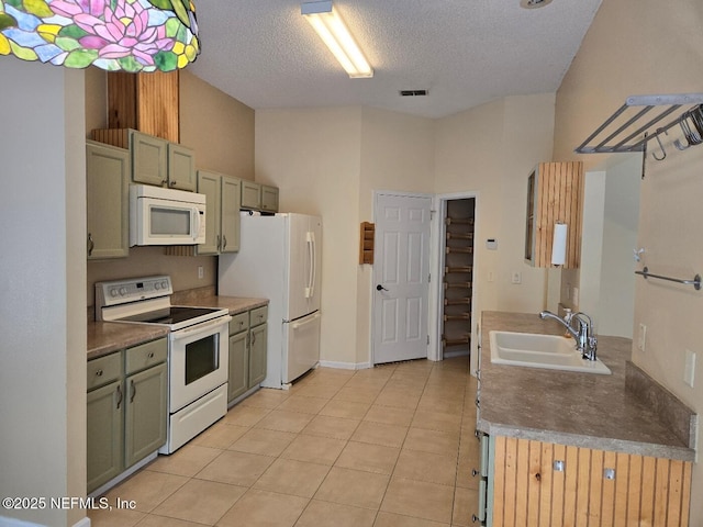 424 Bay Point Way N, Saint Johns, FL 32259 - kitchen featuring white appliances, a sink, a textured ceiling, light tile patterned flooring, and dark countertops