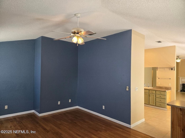 424 Bay Point Way N, Saint Johns, FL 32259 - unfurnished room with ceiling fan, a sink, light wood finished floors, a textured ceiling, and baseboards