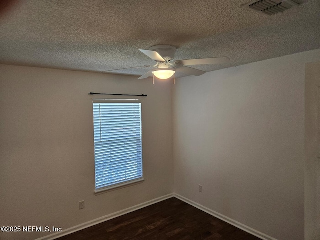 424 Bay Point Way N, Saint Johns, FL 32259 - spare room with dark wood-type flooring, ceiling fan, baseboards, and a textured ceiling