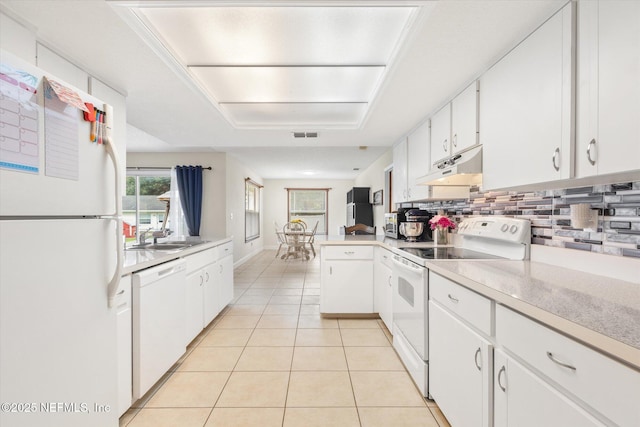 2910 Yule Tree Dr, Edgewater, FL 32141 - kitchen featuring white appliances, under cabinet range hood, backsplash, white cabinets, and light countertops