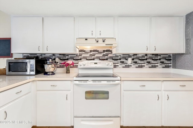 2910 Yule Tree Dr, Edgewater, FL 32141 - kitchen with stainless steel microwave, white electric range, under cabinet range hood, light countertops, and white cabinets