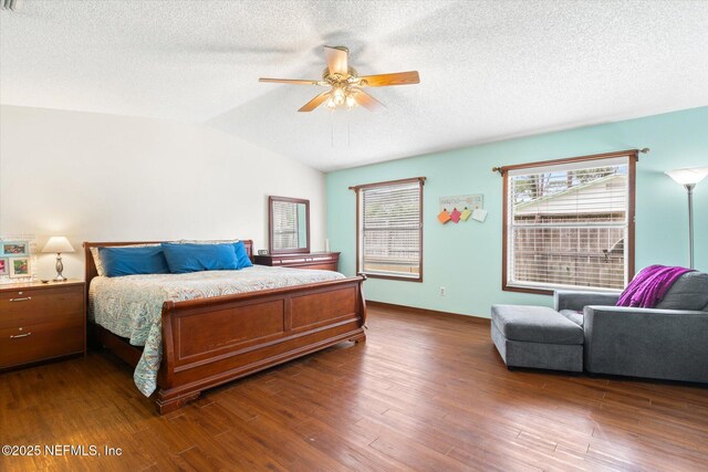 2910 Yule Tree Dr, Edgewater, FL 32141 - bedroom with dark wood-style floors, a textured ceiling, lofted ceiling, and ceiling fan
