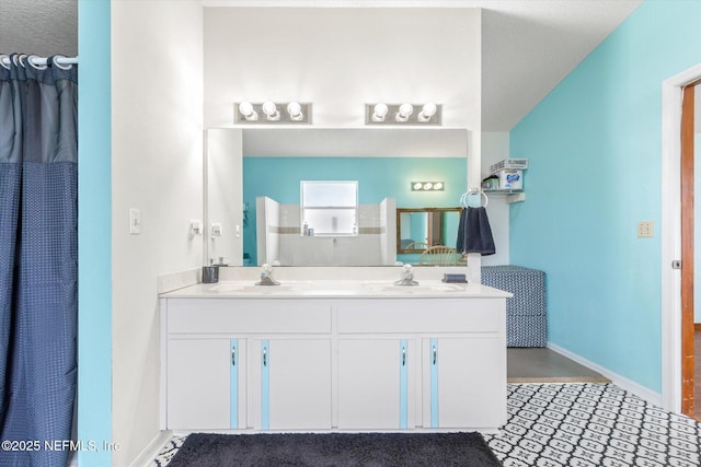 2910 Yule Tree Dr, Edgewater, FL 32141 - full bathroom with double vanity and baseboards