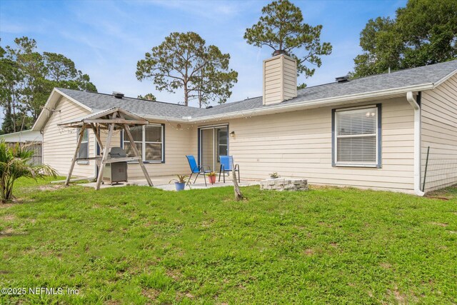 2910 Yule Tree Dr, Edgewater, FL 32141 - back of house with a patio area, a chimney, and a yard