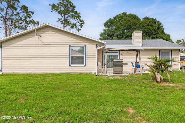 2910 Yule Tree Dr, Edgewater, FL 32141 - back of property with a patio, a yard, and a chimney