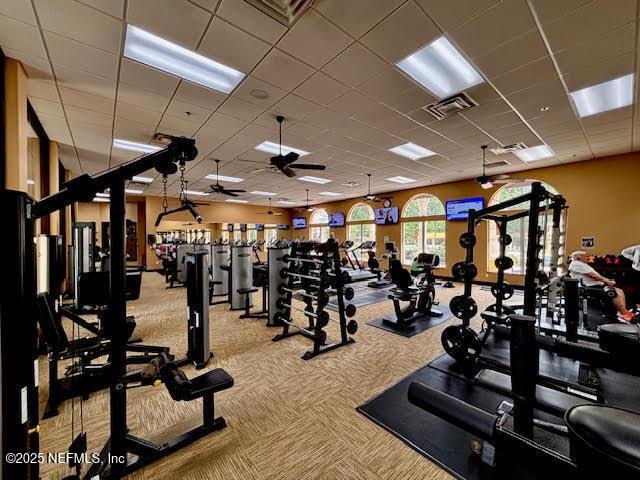 8561 Little Swift Cir Unit 32D, Jacksonville, FL 32256 - workout area featuring a ceiling fan and carpet flooring