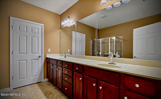 8561 Little Swift Cir Unit 32D, Jacksonville, FL 32256 - bathroom featuring double vanity, a stall shower, tile patterned floors, and baseboards