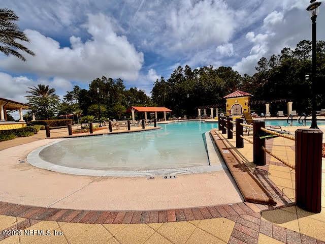 8561 Little Swift Cir Unit 32D, Jacksonville, FL 32256 - community pool featuring a patio area