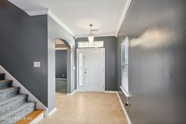 96290 Coral Reef Rd, Yulee, FL 32097 - foyer with arched walkways, crown molding, light tile patterned floors, baseboards, and stairs