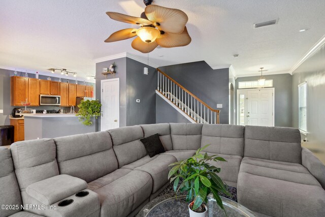 96290 Coral Reef Rd, Yulee, FL 32097 - living room with stairway, ornamental molding, rail lighting, and ceiling fan