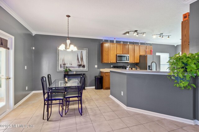 96290 Coral Reef Rd, Yulee, FL 32097 - kitchen featuring stainless steel appliances, a chandelier, crown molding, brown cabinets, and light countertops
