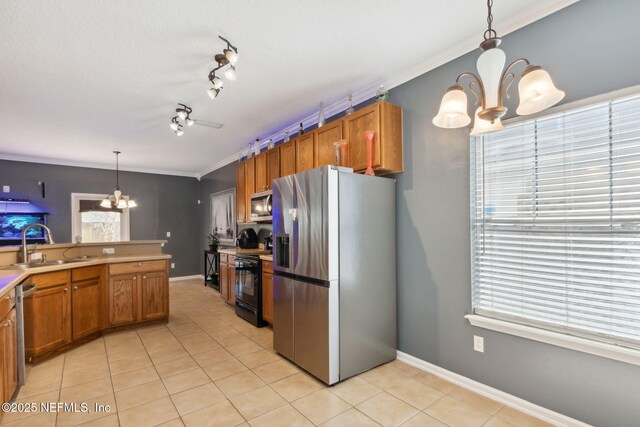 96290 Coral Reef Rd, Yulee, FL 32097 - kitchen with a chandelier, stainless steel appliances, brown cabinets, light tile patterned flooring, and a sink