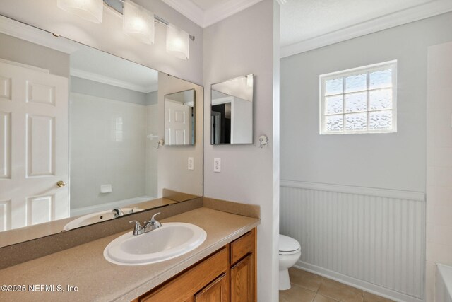 96290 Coral Reef Rd, Yulee, FL 32097 - bathroom featuring toilet, crown molding, vanity, tile patterned floors, and wainscoting
