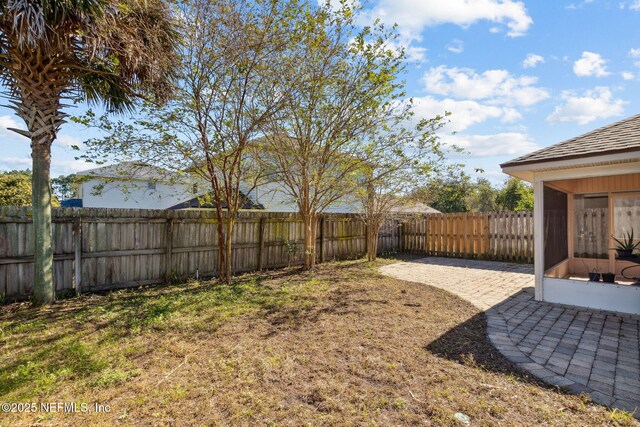96290 Coral Reef Rd, Yulee, FL 32097 - fenced backyard with a sunroom and a patio area