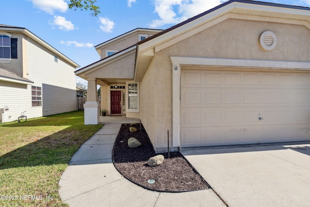96290 Coral Reef Rd, Yulee, FL 32097 - view of front of property with stucco siding, a front yard, a garage, and concrete driveway