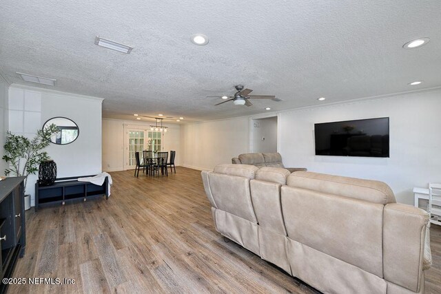4966 Harvey Grant Rd, Fleming Island, FL 32003 - living area featuring wood finished floors, a textured ceiling, crown molding, ceiling fan, and recessed lighting