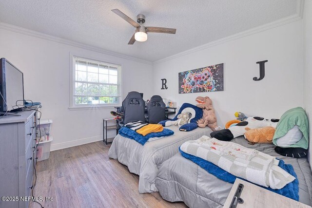 4966 Harvey Grant Rd, Fleming Island, FL 32003 - bedroom featuring light wood finished floors, a textured ceiling, crown molding, baseboards, and ceiling fan