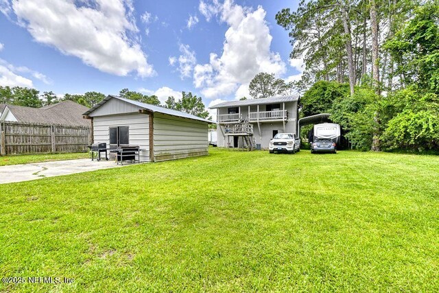 4966 Harvey Grant Rd, Fleming Island, FL 32003 - rear view of house with a carport and an outbuilding
