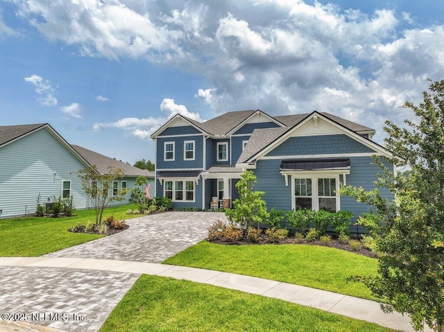 105 Awlleaf Ct, Saint Augustine, FL 32095 - craftsman-style house with decorative driveway and a front lawn