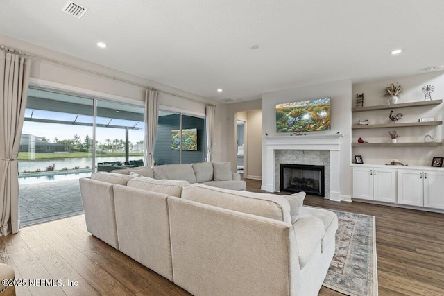 105 Awlleaf Ct, Saint Augustine, FL 32095 - living room with dark wood-style floors, a water view, a fireplace, and recessed lighting