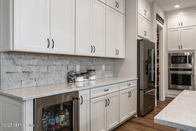 105 Awlleaf Ct, Saint Augustine, FL 32095 - kitchen with stainless steel appliances, beverage cooler, white cabinets, light stone countertops, and dark wood-type flooring