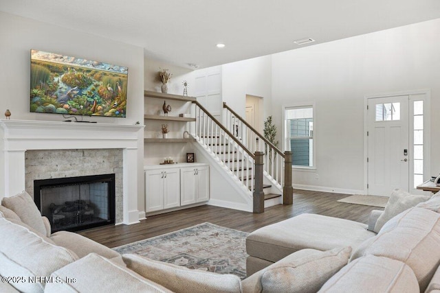 105 Awlleaf Ct, Saint Augustine, FL 32095 - living room featuring stairway, dark wood-style flooring, a stone fireplace, and recessed lighting