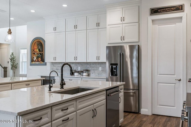 105 Awlleaf Ct, Saint Augustine, FL 32095 - kitchen featuring appliances with stainless steel finishes, an island with sink, decorative backsplash, white cabinetry, and dark wood-type flooring