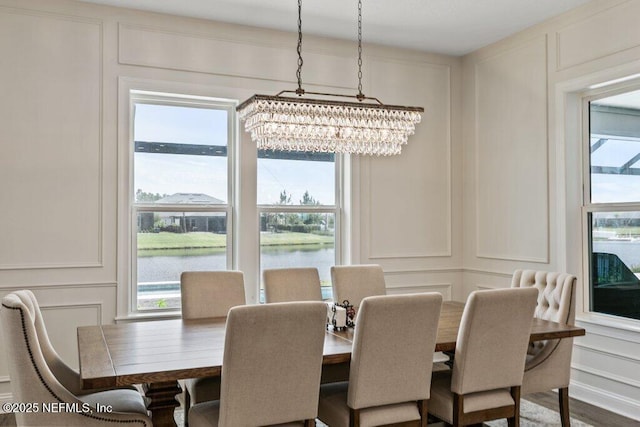 105 Awlleaf Ct, Saint Augustine, FL 32095 - dining room featuring a decorative wall, a chandelier, plenty of natural light, and a water view