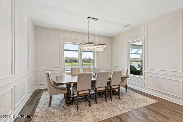 105 Awlleaf Ct, Saint Augustine, FL 32095 - dining room featuring a decorative wall, dark wood finished floors, and a chandelier