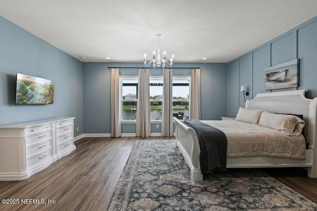 105 Awlleaf Ct, Saint Augustine, FL 32095 - bedroom with a chandelier, wood finished floors, a textured ceiling, a water view, and recessed lighting